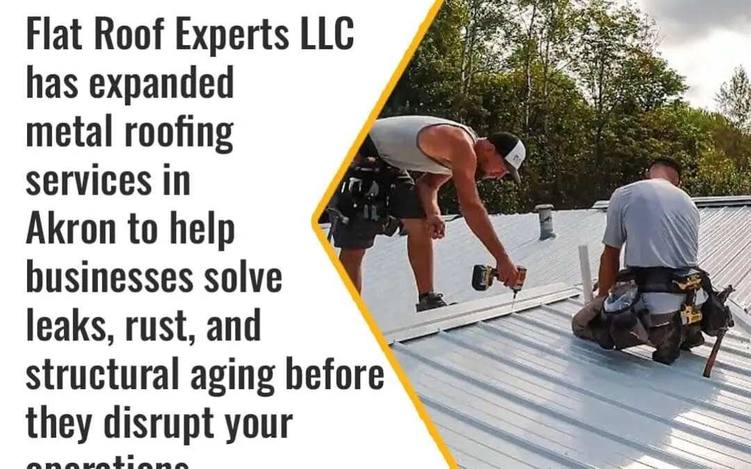 Roofing contractors installing metal roofing panels on a commercial building in Akron, Ohio