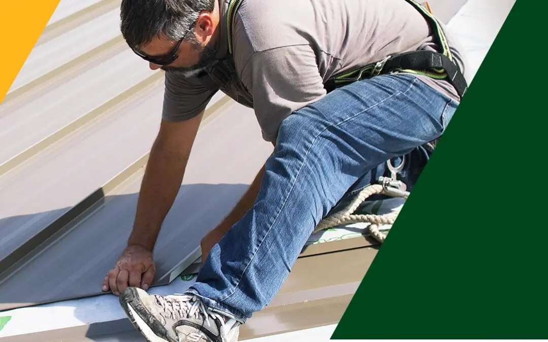 A roofing contractor in a safety harness securing standing seam metal roof panels, featured with official Flat Roof Experts branding.